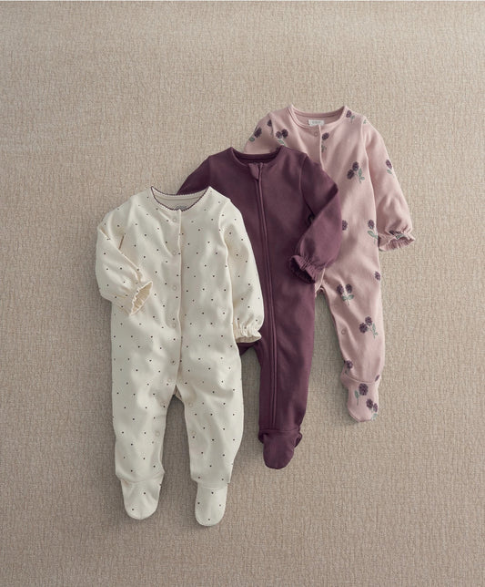 Three-pack baby sleepsuits: white speckle, plum zip, blush floral prints