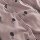 Blush floral baby sleepsuit with button placket and long sleeves