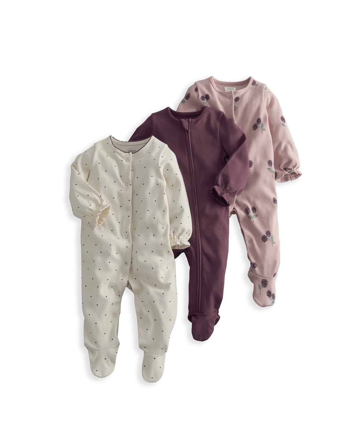 Three-pack baby sleepsuits in white speckle, plum zip, and blush floral prints