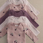 5-pack baby bodysuits: pale pink, plum purple, and light pink with berry print