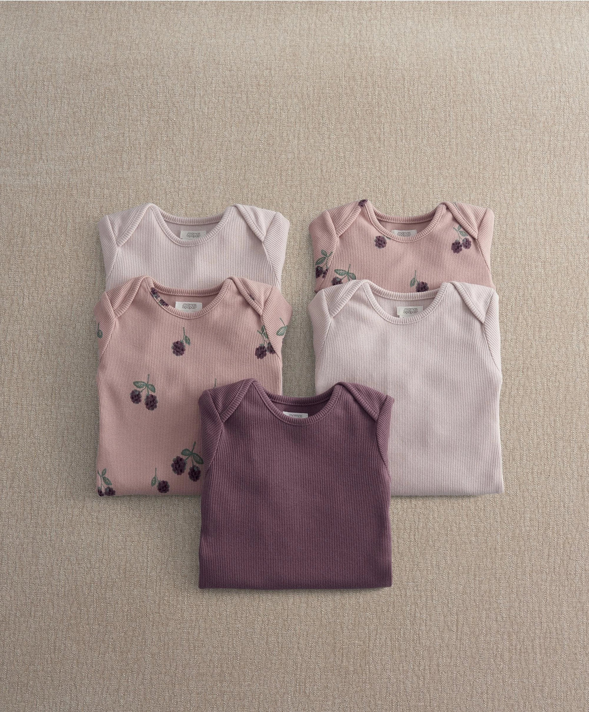 5-pack baby bodysuits in light pink, plum purple, and white with berry-and-leaf print