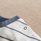 Striped long-sleeve T-shirt with blue snap placket and ribbed cuffs