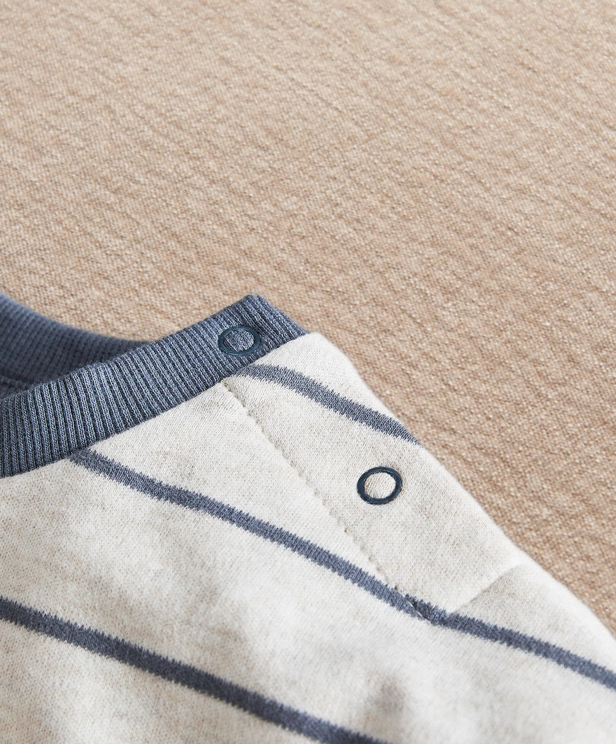 Striped long-sleeve T-shirt with blue snap placket and ribbed cuffs