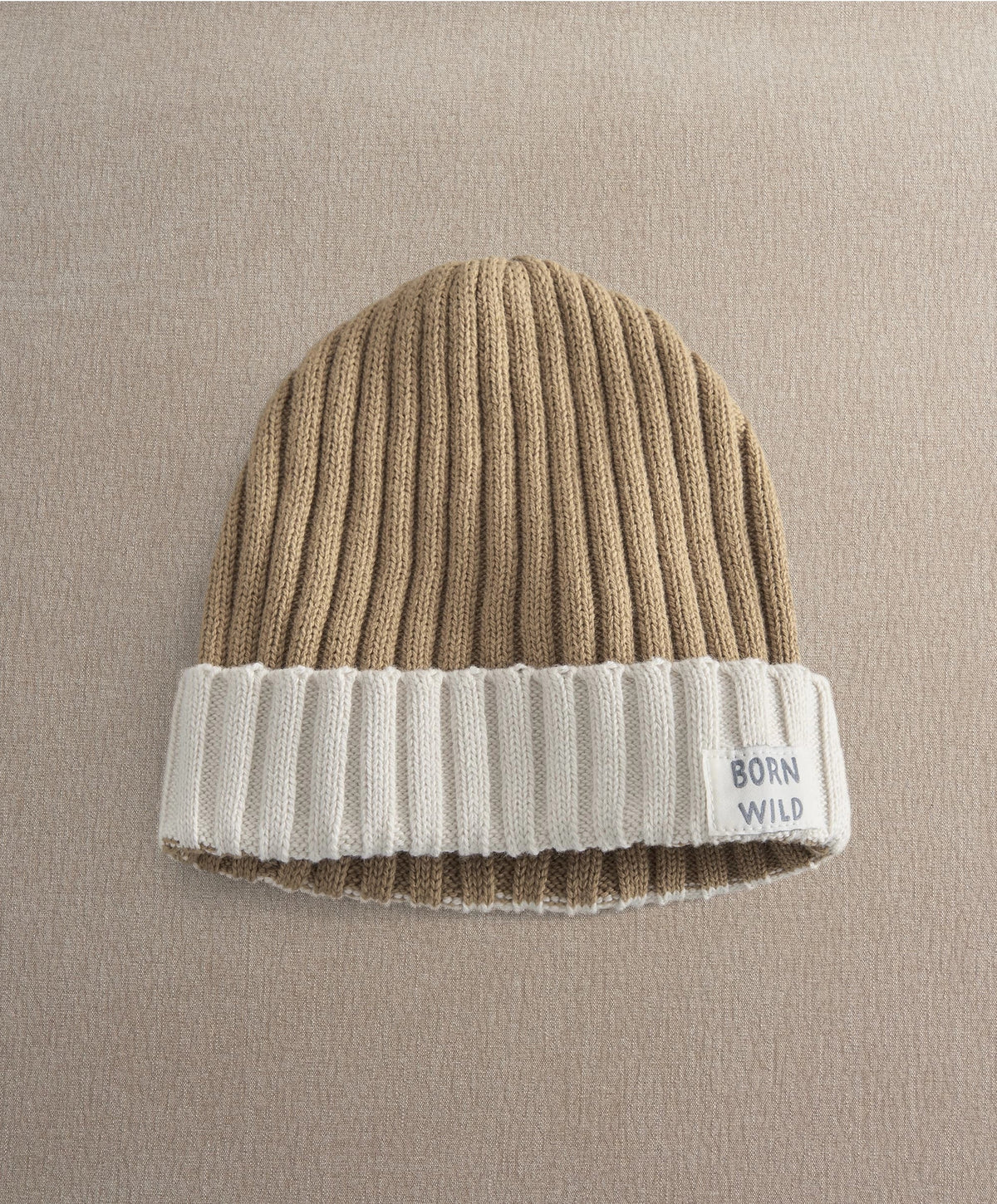 Brown and white knitted beanie with ribbed knit and BORN WILD logo patch
