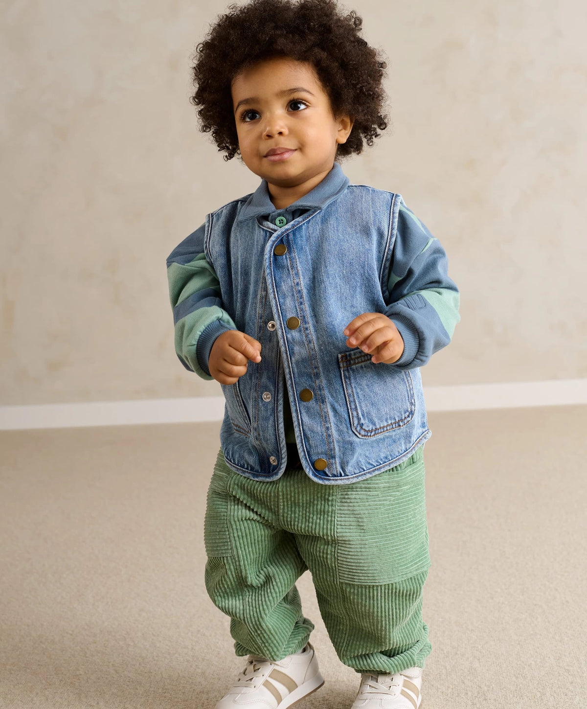 Kids green cord trousers with elastic waist, relaxed fit and cuffed hems