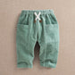 Green cord trousers, elastic waistband with tie, side patch pockets, full length