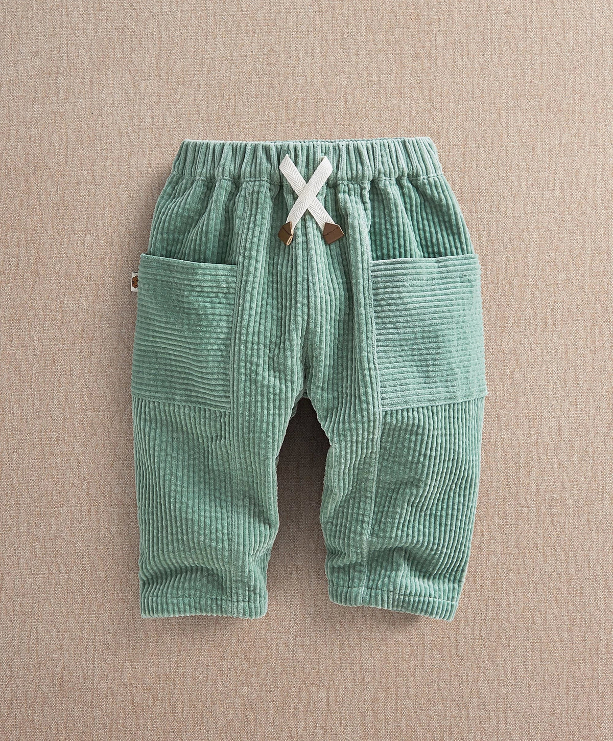 Green cord trousers, elastic waistband with tie, side patch pockets, full length