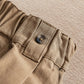 Tan waistband detail with belt loops and button