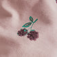 Pink fabric with green leaves and dark berry bramble print
