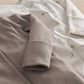 Gray ribbed button-front top with long sleeves; white printed footie with snaps