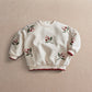 Cream berry sweatshirt with full front berry and leaf motif, long puff sleeves