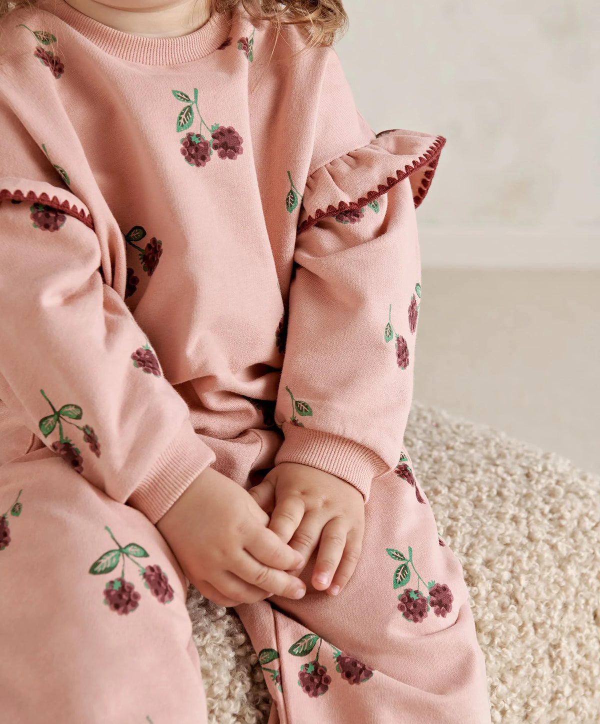 Light pink toddler sweatshirt with berry-and-leaf print and ruffled cuff