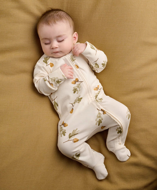 White acorn & leaf print zip-front baby all-in-one with footed legs