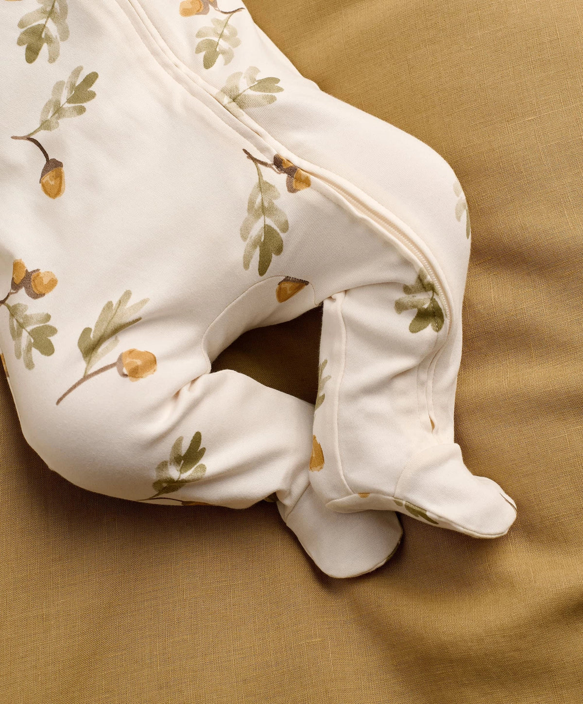 White acorn & leaf print all-in-one with zip edge and footed cuffs