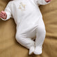 White baby all-in-one romper with duck Hello World embroidery on front
