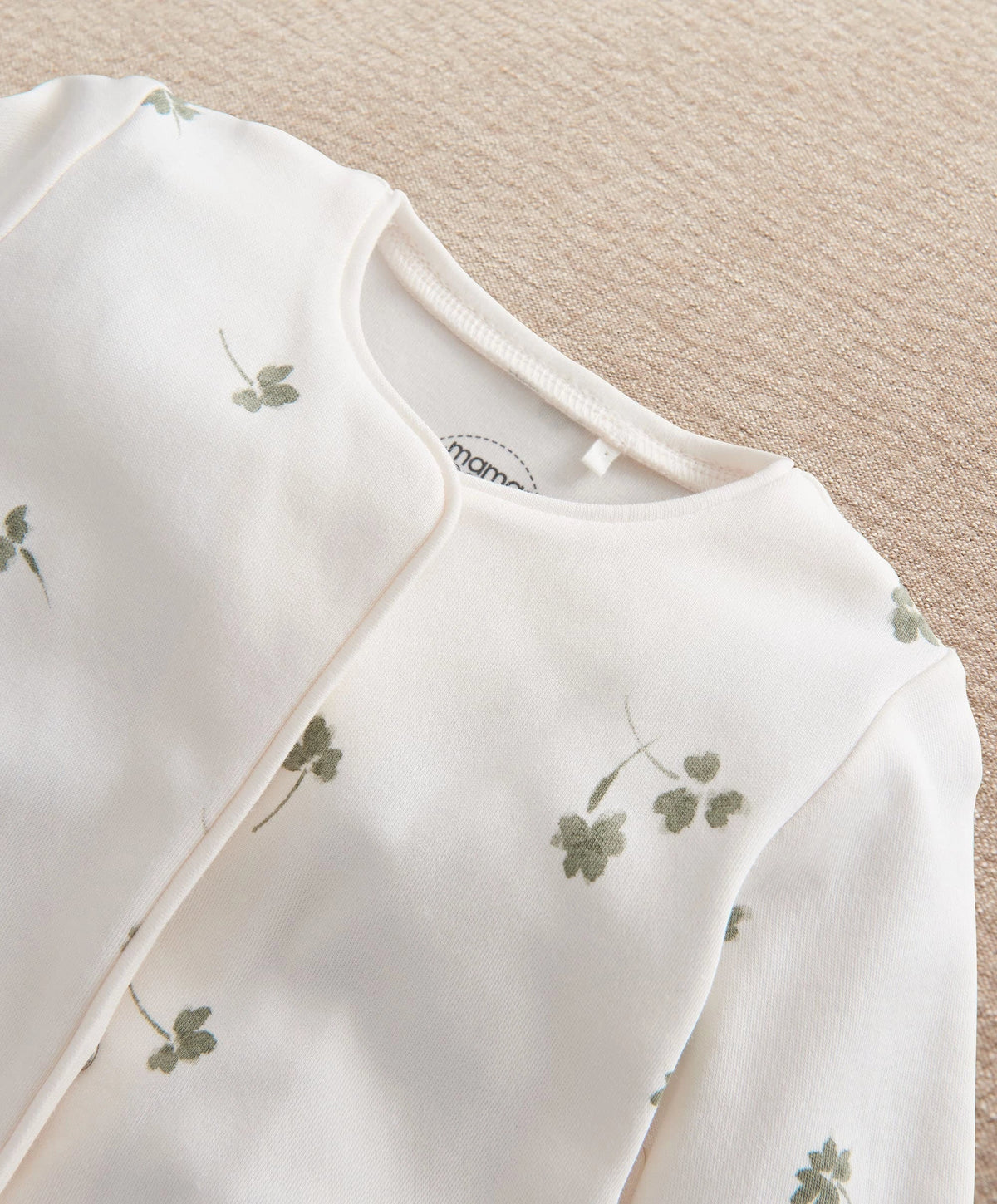 Clover-print baby romper with ribbed neckline and snap buttons