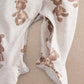 White bear print all-in-one with snap crotch and footed openings at cuffs.