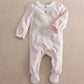 Pink footed baby onesie with long sleeves and embroidered 'born in 2027' on front