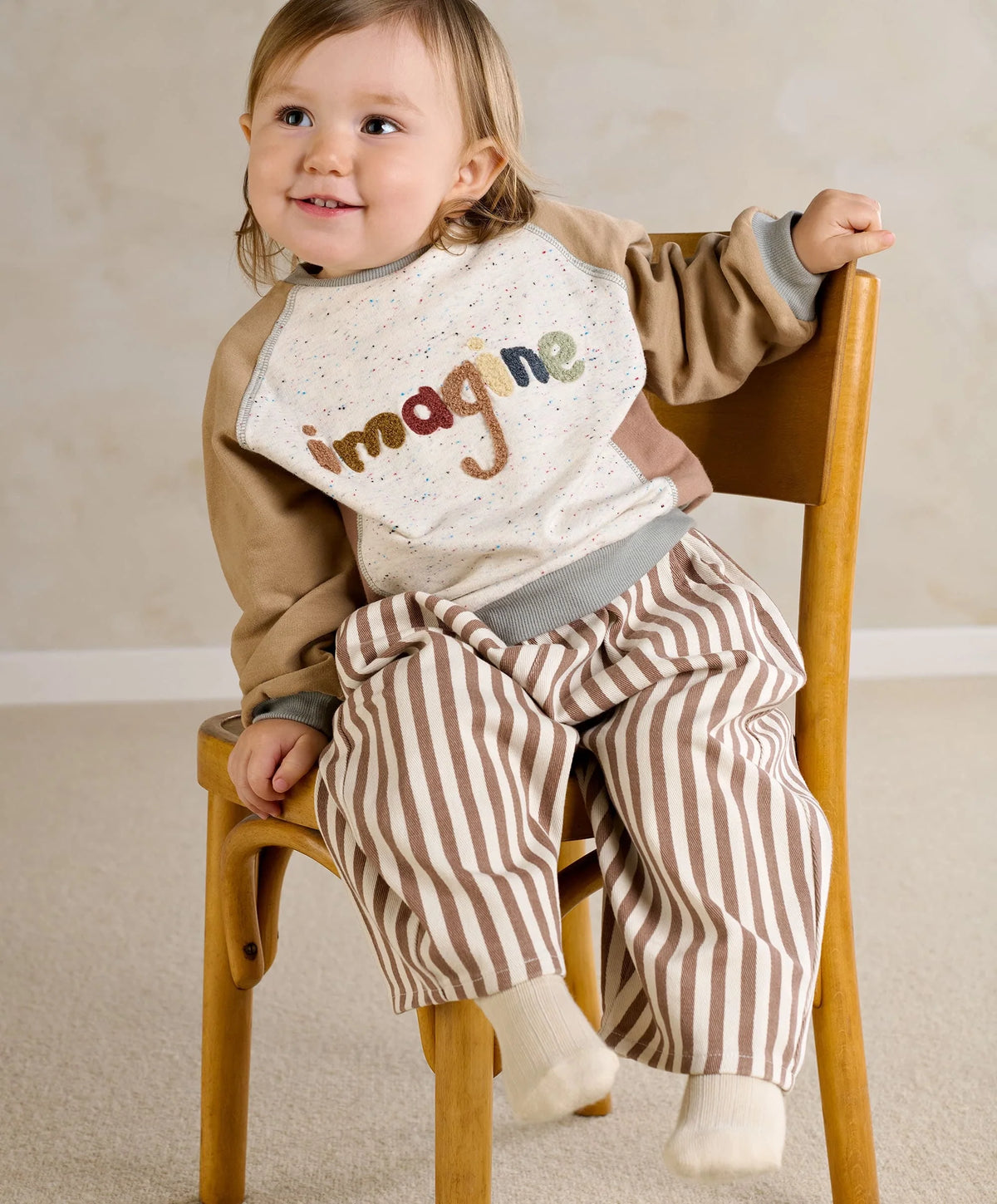 Raglan sweatshirt on child: speckled front with 'imagine' print, beige sleeves, gray cuffs