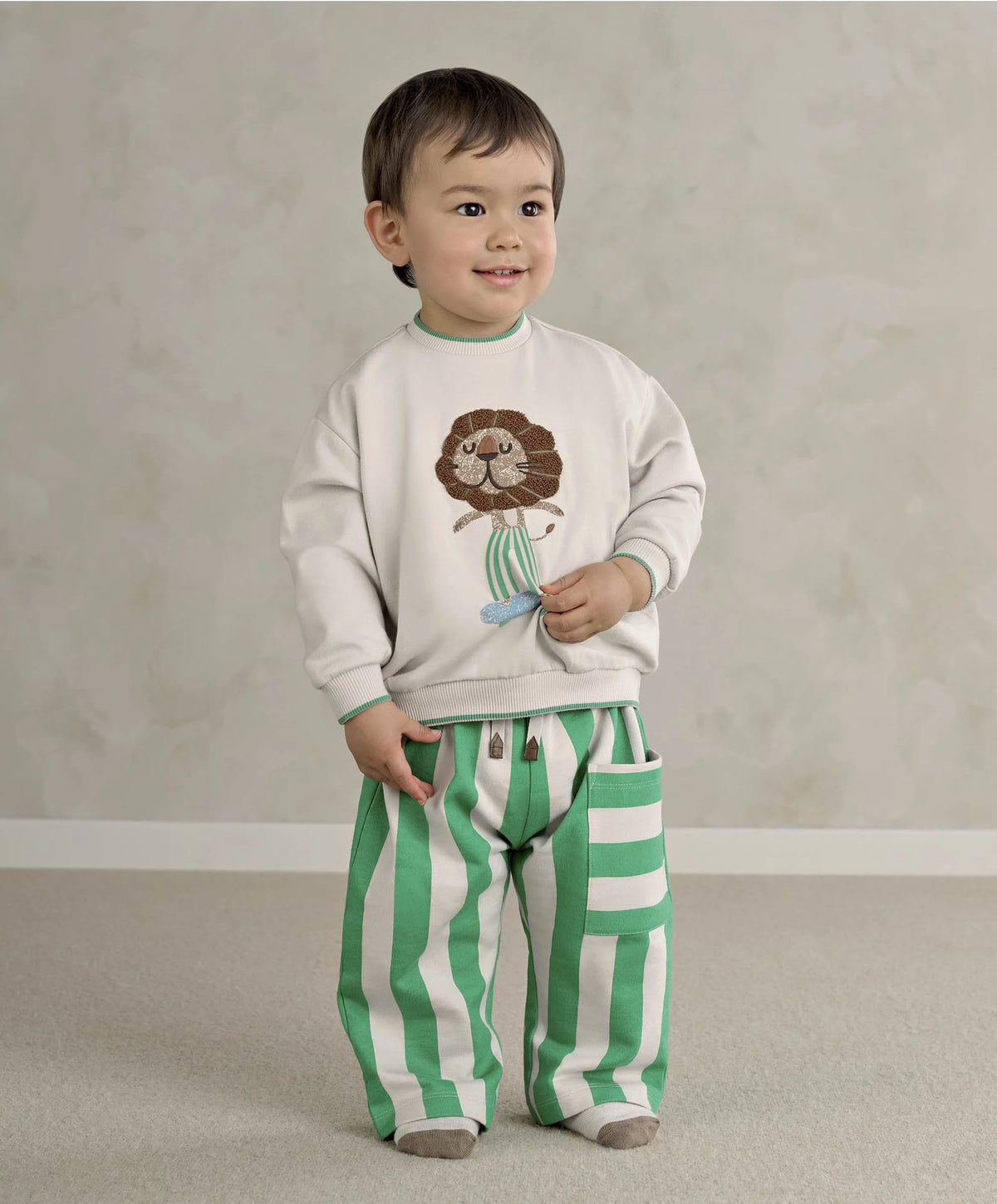 White toddler sweatshirt with lion face applique and teal ribbed hem