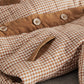 Checked jacket chest pocket detail with corduroy panel and button snaps