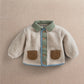 Cream borg jacket with mint collar, blue button placket, and tan front pockets