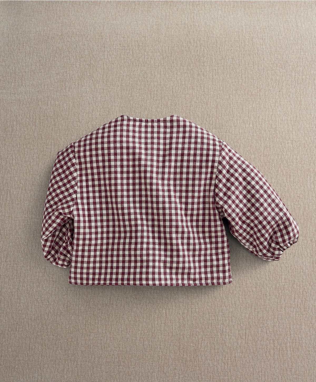 Red gingham jacket back view with balloon sleeves and gathered cuffs