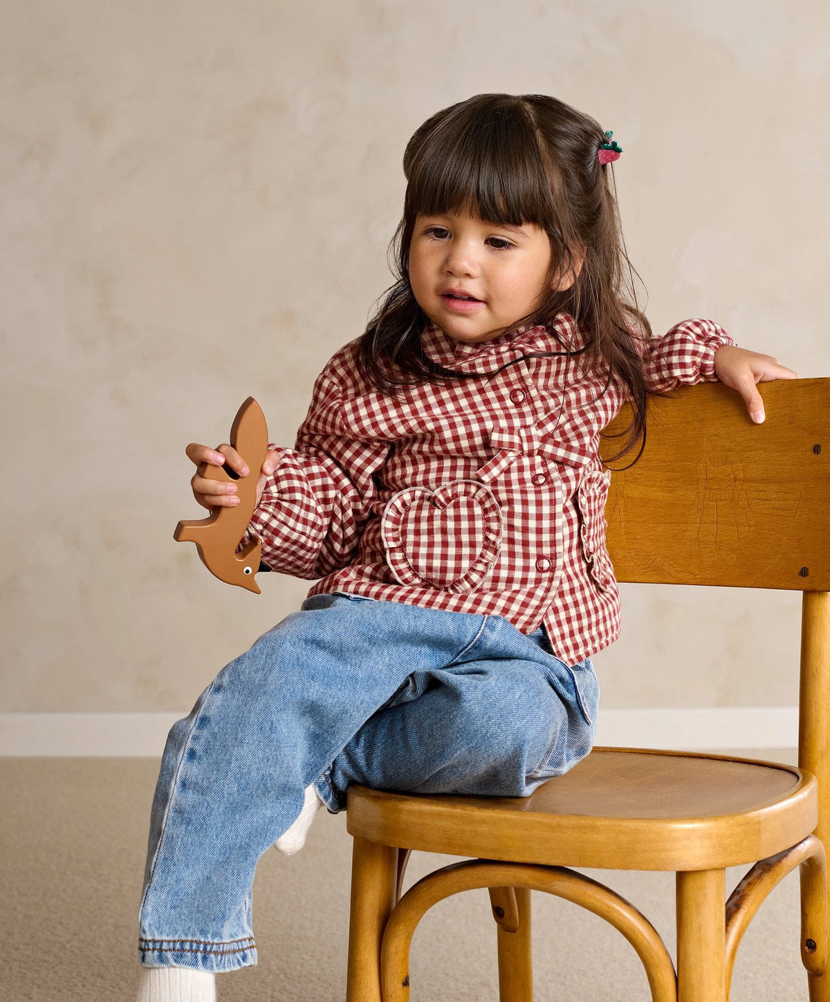 Red gingham jacket with heart pocket detail and ruffled bow neckline
