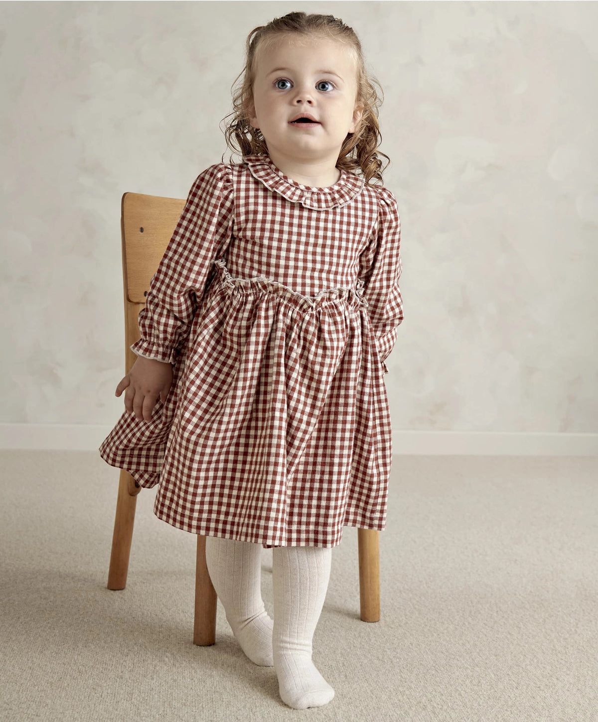 Red and white gingham long-sleeve dress with gathered skirt and ruffled neckline