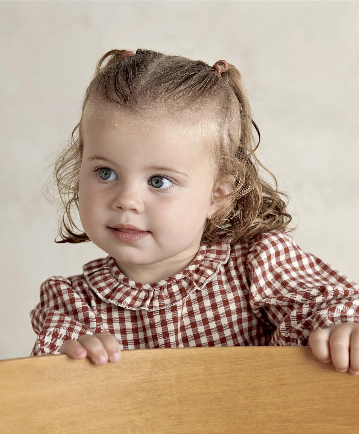 Red and white gingham dress close-up with ruffled collar and long puff sleeves