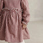Red and white gingham dress with gathered waist, flared skirt, and gathered cuffs