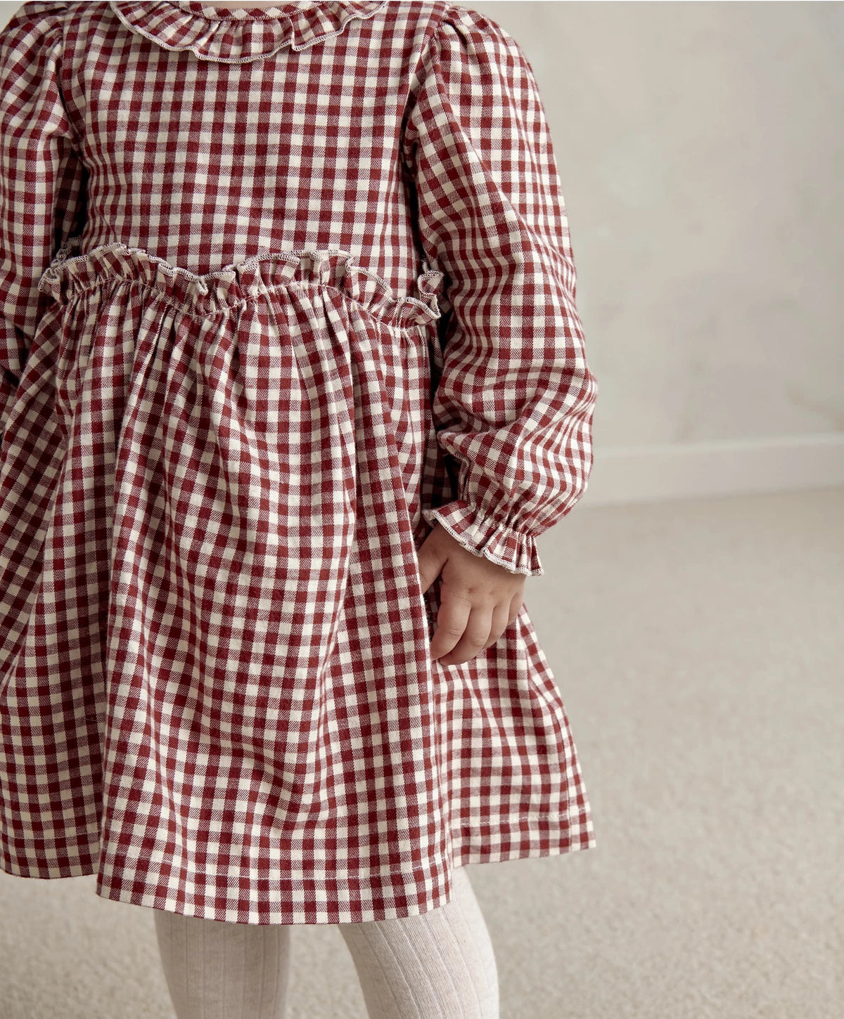 Red and white gingham dress with gathered waist, flared skirt, and gathered cuffs