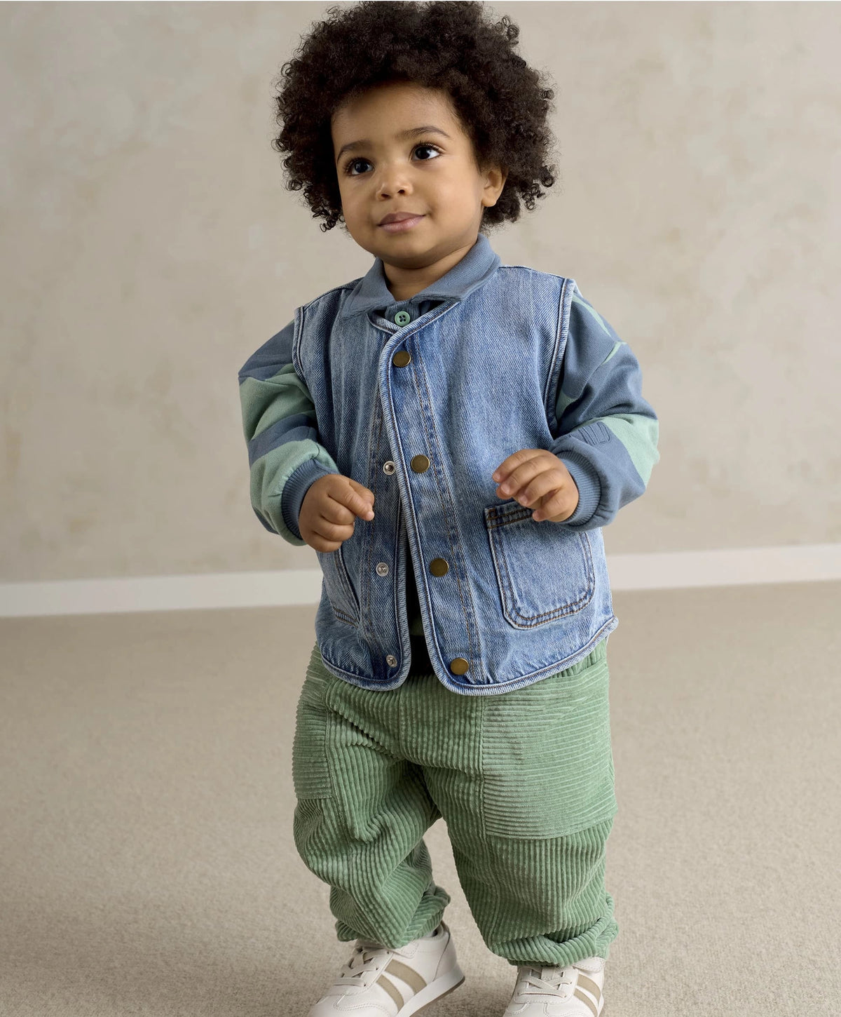 Blue denim sleeveless gilet with button front and two chest pockets