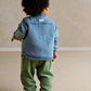 Blue denim sleeveless gilet back view with stand collar and button placket