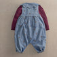 Denim dungaree romper with embroidered bows, burgundy long sleeves, scalloped bib yoke