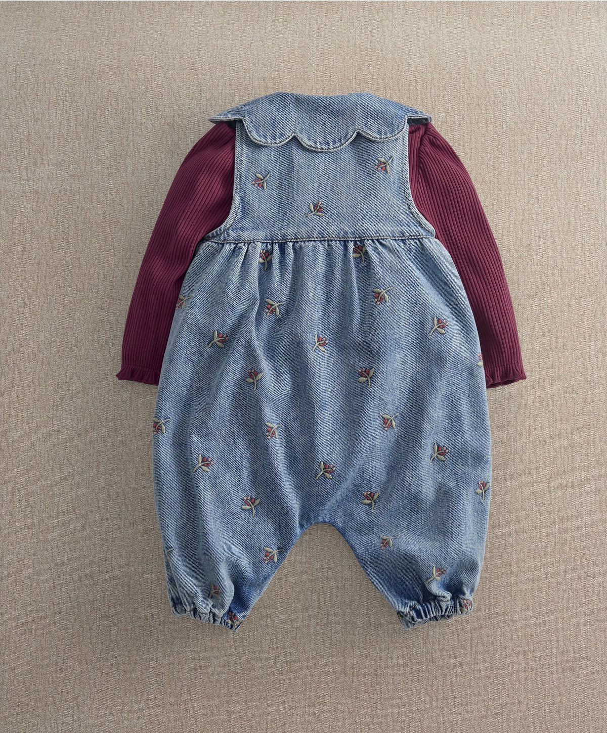Denim dungaree romper with embroidered bows, burgundy long sleeves, scalloped bib yoke