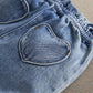 Heart-shaped pocket on denim shorts with elastic waistband and topstitching