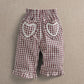 Red gingham trousers with heart patch pockets and ruffled hems