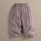Red gingham trousers with elastic waist and gathered ruffle hem