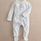White footed baby all-in-one romper with long sleeves and embroidered chest