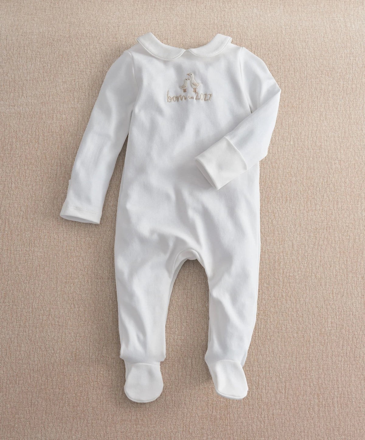 White footed baby all-in-one romper with long sleeves and embroidered chest