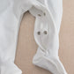 White baby all-in-one romper with snap neck closure