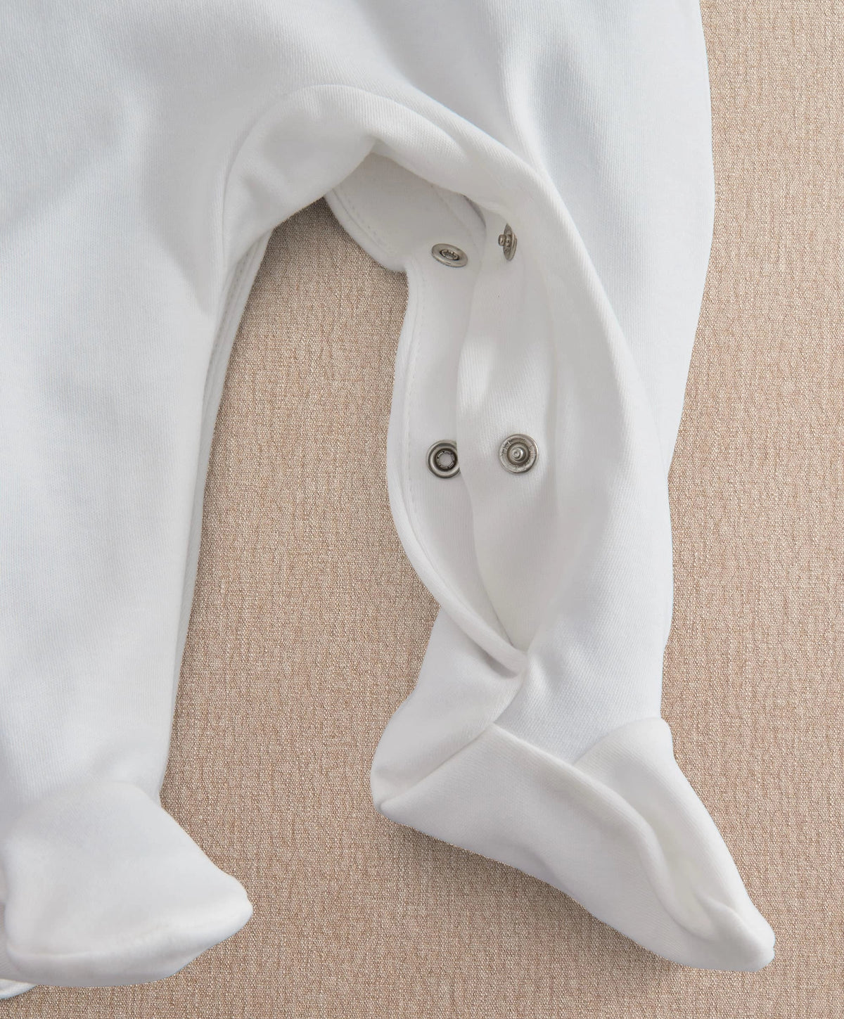 White baby all-in-one romper with snap neck closure
