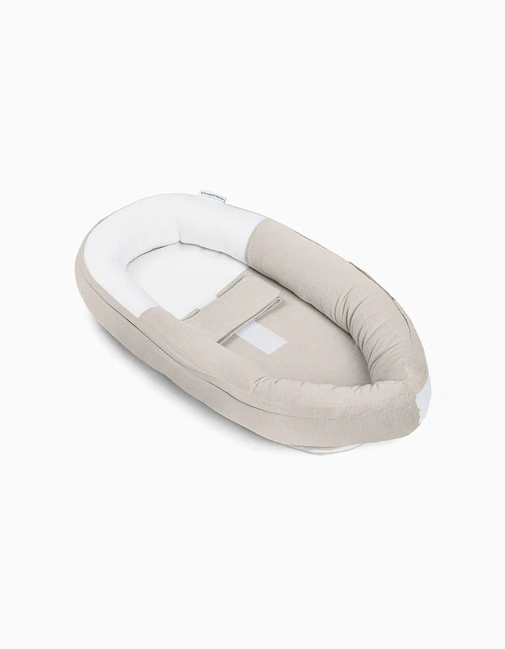 Sand beige baby cocoon nest with white inner cushion, rounded edges