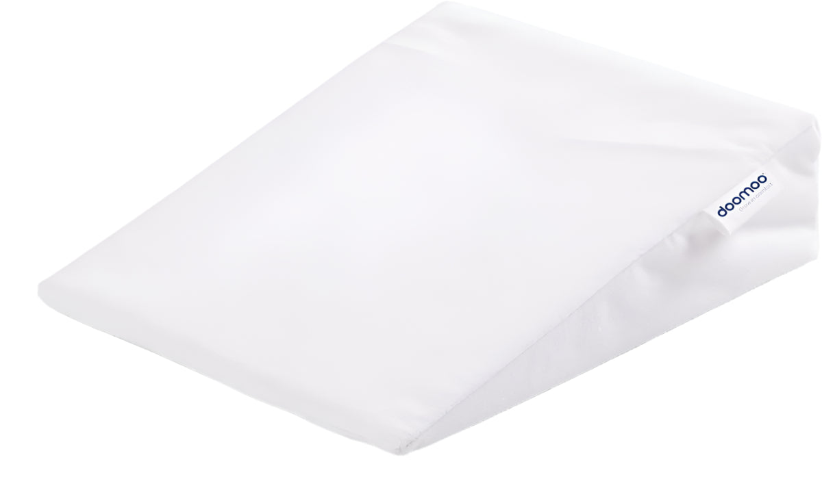 Small baby rest pillow with white cover, 80% bamboo side label, angled view