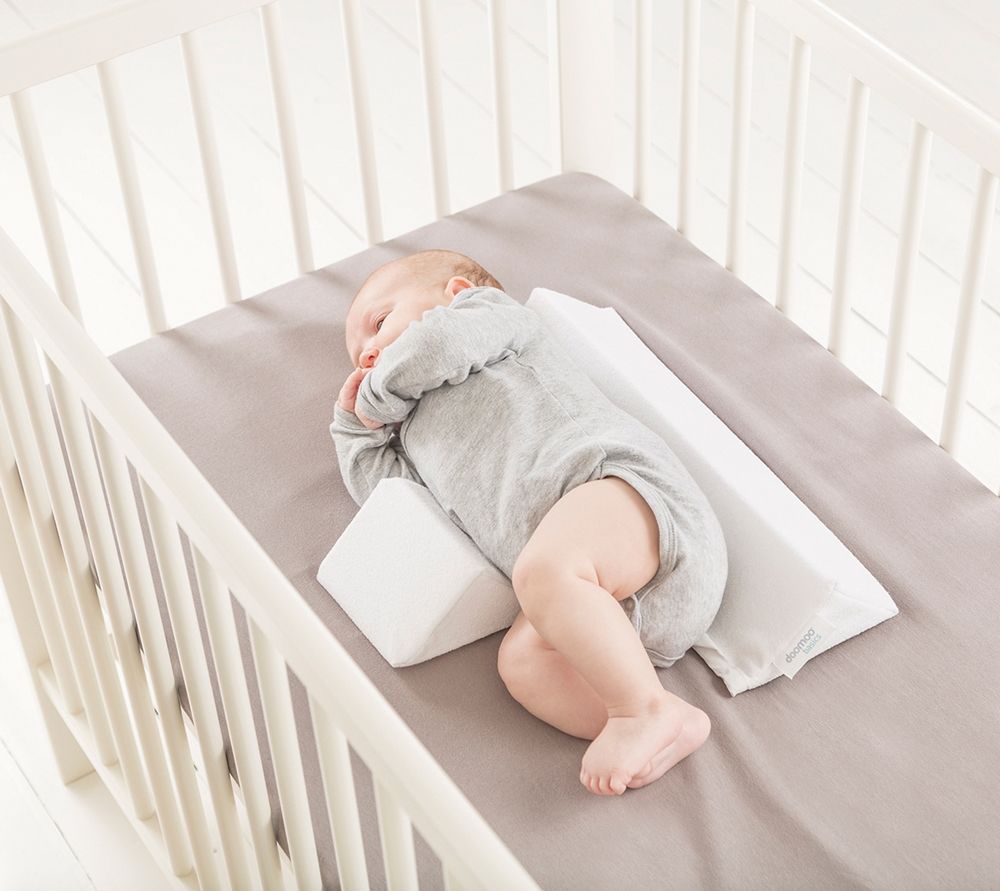 Baby sleep pillow on crib bedding, light gray rectangular design