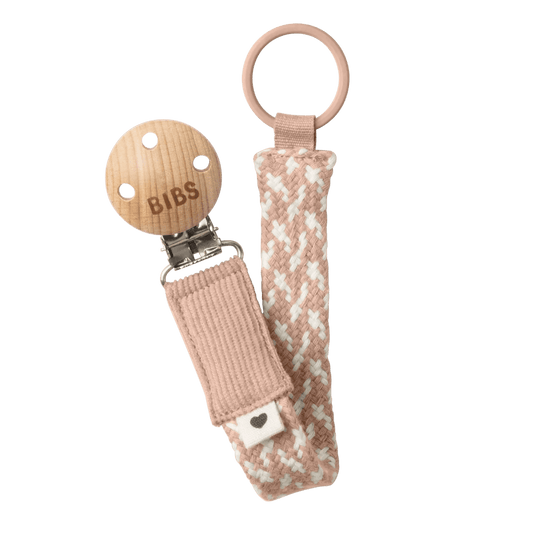 Woven pacifier clip with blush-and-ivory strap, BIBS tag, and metal clasp