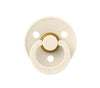 Blush latex pacifier with gold ring and round mouth shield, front view