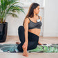 Breast pump spare parts kit in use under gray sports bra, pump cup at chest