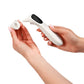 White non-contact infrared thermometer in hand, black sensor tip with reading screen